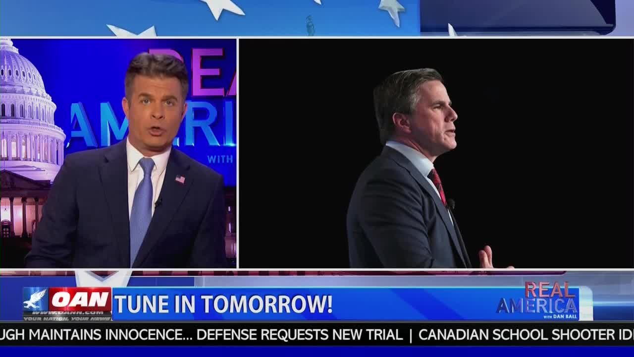 A man in a suit speaks with his hands gesturing, his profile silhouetted against a black background. Beside him, a news anchor with a blue tie looks directly at the camera, a graphic of the U.S. Capitol behind him.