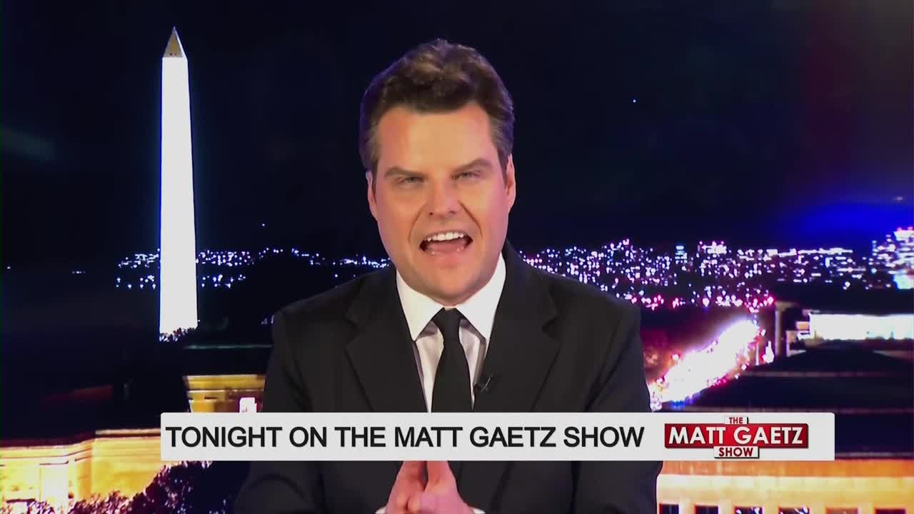 The Washington Monument stands tall against the night sky. Matt Gaetz speaks directly to the camera, his hands clasped in front of him.