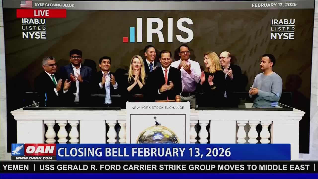 A group of people in business attire stands on a platform, clapping. The New York Stock Exchange logo is visible behind them.