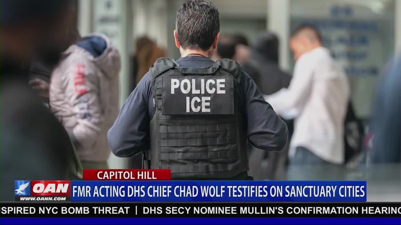 An officer in a tactical vest with "POLICE ICE" clearly visible walks forward, his back to me. People mill about in the background, some blurred, as a news ticker from One America News Network scrolls below.