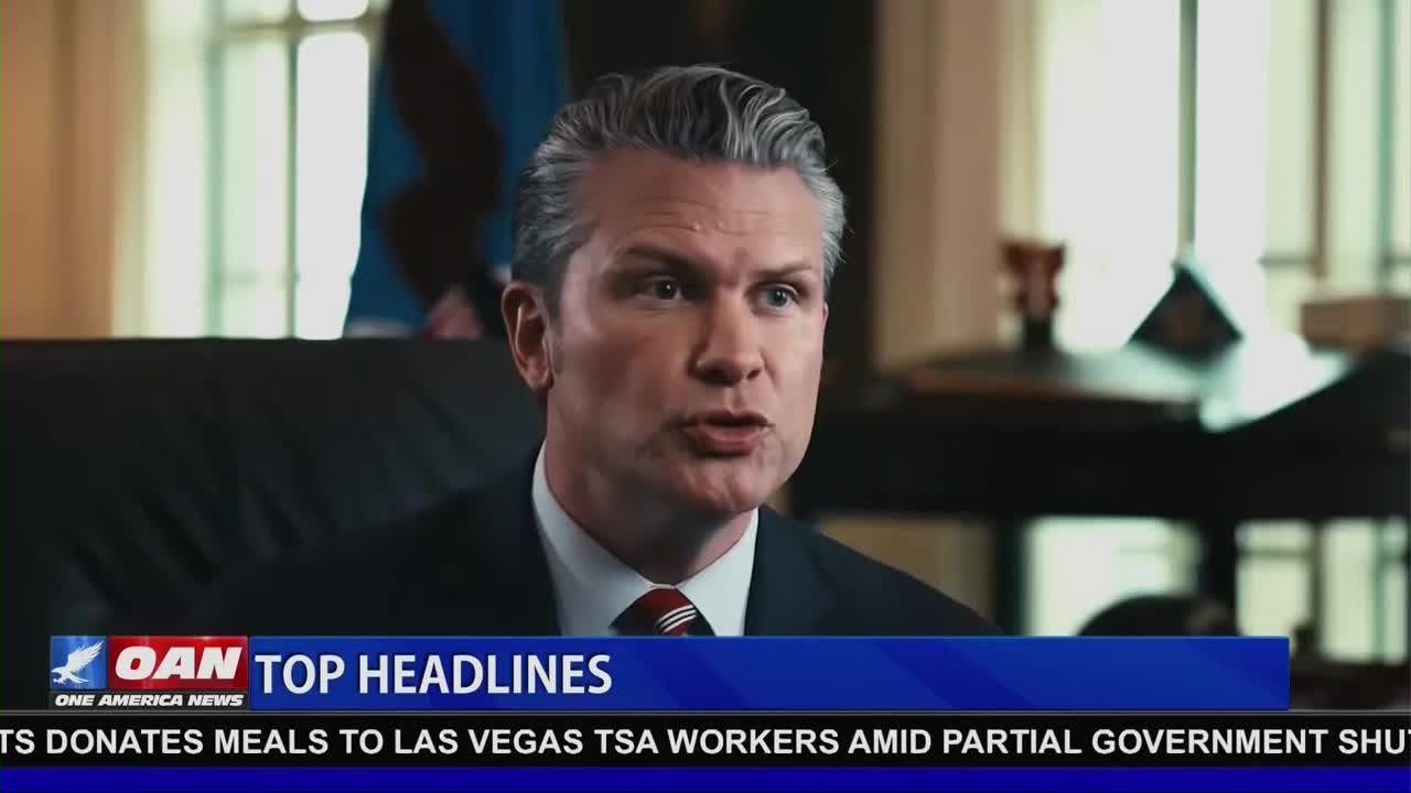 A man in a suit speaks directly to the camera, his silver hair neatly styled. Below him, a news ticker scrolls, reporting on One America News Network's top headlines.