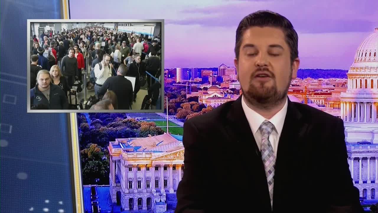 A crowd of people stands in a long line inside what looks like an airport terminal. A news anchor speaks in front of a backdrop of Washington D.C. buildings.