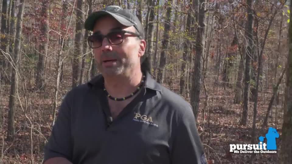 A man in sunglasses and a cap is talking, framed by a backdrop of bare trees. The Pursuit Channel logo is visible in the bottom right corner.
