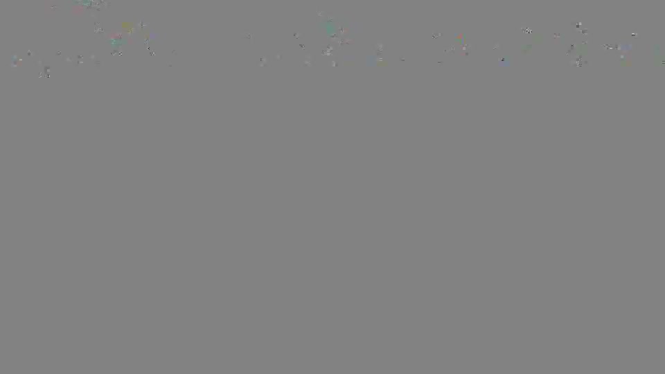 The sky is overcast, a muted blend of grays and greens.  A few indistinct shapes are barely visible against the horizon.
