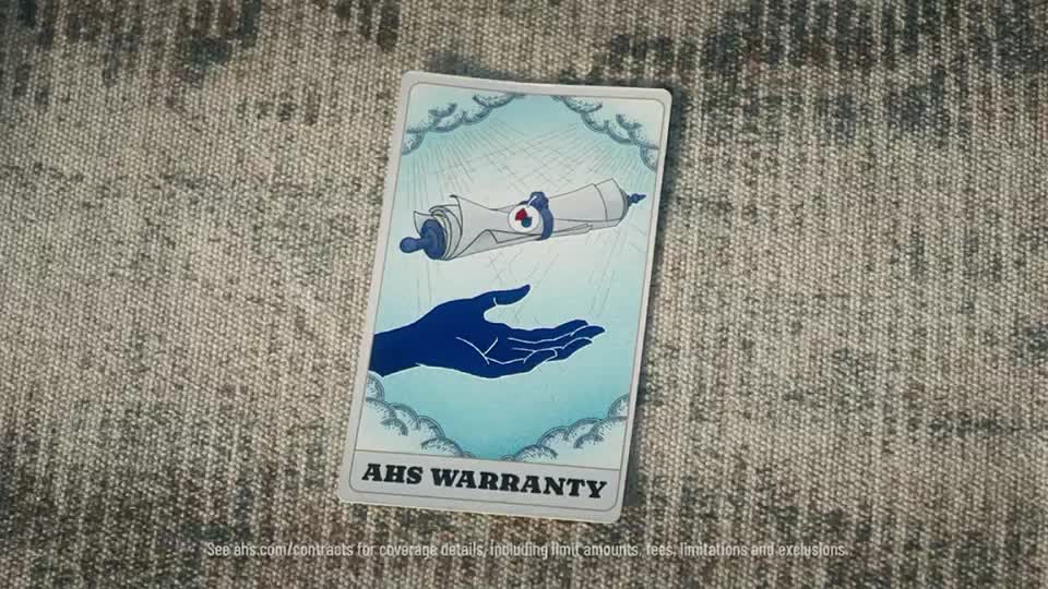 A card with a blue hand and a rolled-up document floats above a light-blue background. The card, labeled "AHS WARRANTY," rests on a textured, neutral surface.
