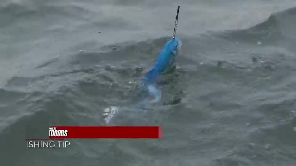 A blue lure, suspended from a line, bobs in the choppy water. The "West Outdoors" segment on Pursuit Channel is showing how to use the "shing tip."

