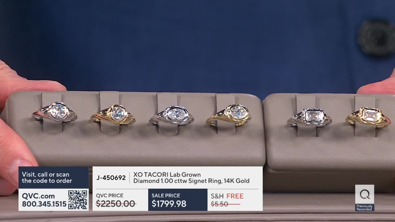 Six diamond rings, set in gold and silver, are displayed on a neutral-toned tray. The QVC logo and price information are visible at the bottom of the screen.
