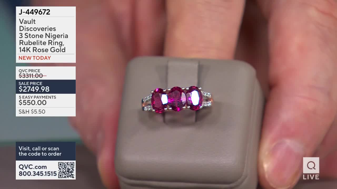 A hand holds a ring with three oval, deep pink stones, set in rose gold. The QVC price and sale price are listed on the left side of the screen.
