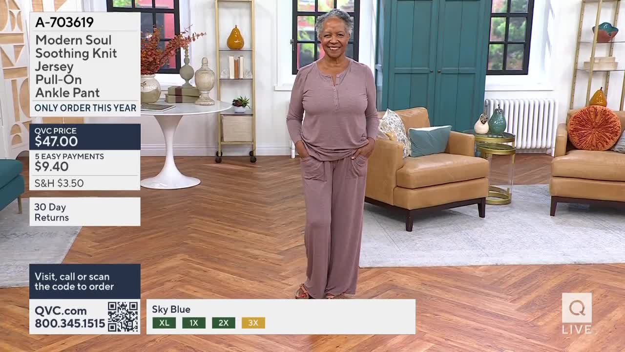 A woman in a mauve knit set stands smiling, hands in her pockets. The QVC price and size availability are displayed on the screen.
