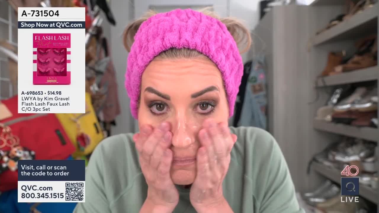 Her hands are gently massaging cleanser into her face. The QVC logo is visible in the lower right corner.