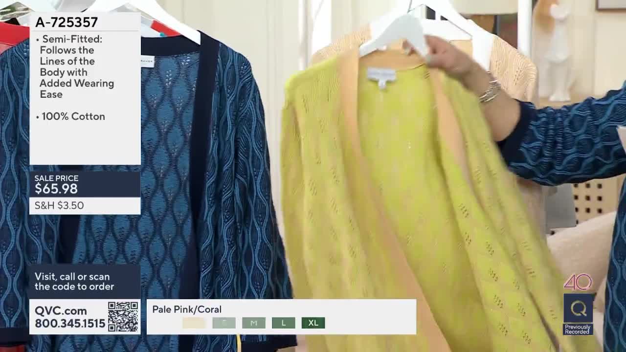 A hand holds up a bright yellow cardigan, its delicate knit catching the light. Beside it, a navy blue cardigan with a repeating wave pattern hangs on a rack.