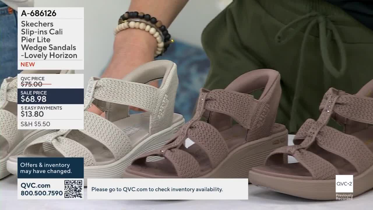 Three pairs of wedge sandals are displayed, each in a different shade of neutral. The QVC2 logo is visible in the lower right corner, with pricing information displayed on the left.
