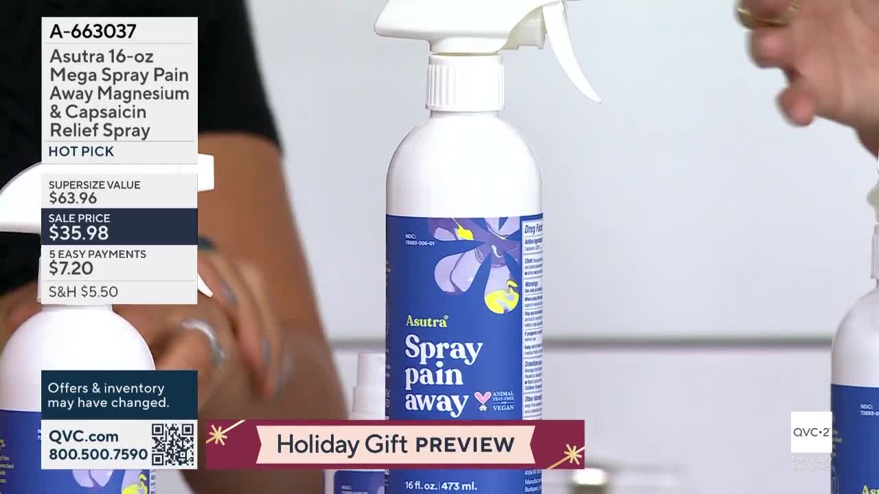 A person is holding a white bottle of pain relief spray, demonstrating its use on QVC2. The product is labeled "Asutra Spray Pain Away" and the screen displays a "Holiday Gift Preview" banner.
