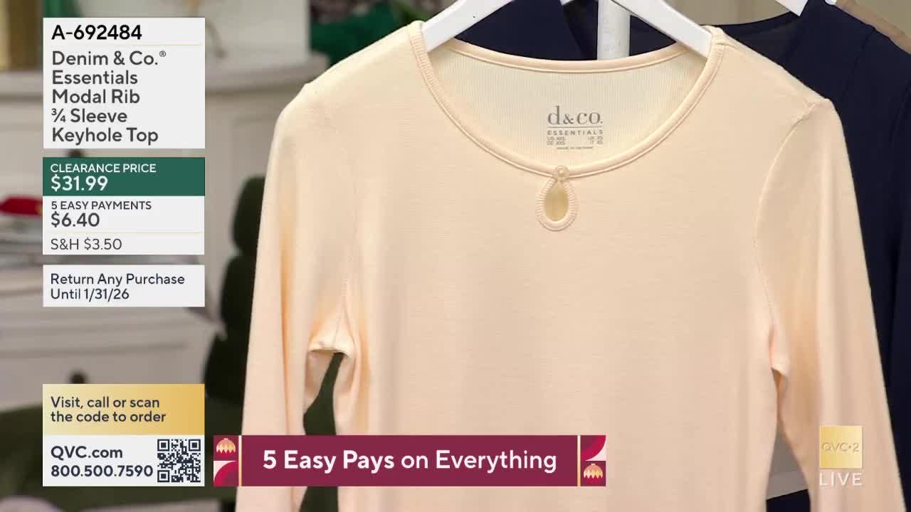 A pale peach-colored top with a keyhole detail hangs on a white hanger, displayed on QVC2. The price and payment options are listed on the left, and the channel logo is in the lower right corner.
