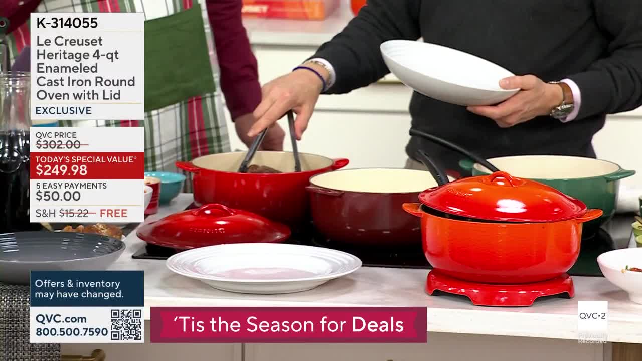 A host on QVC2 uses tongs to lift something from a red enameled Dutch oven. He holds a white plate in his other hand, presumably to serve the food.
