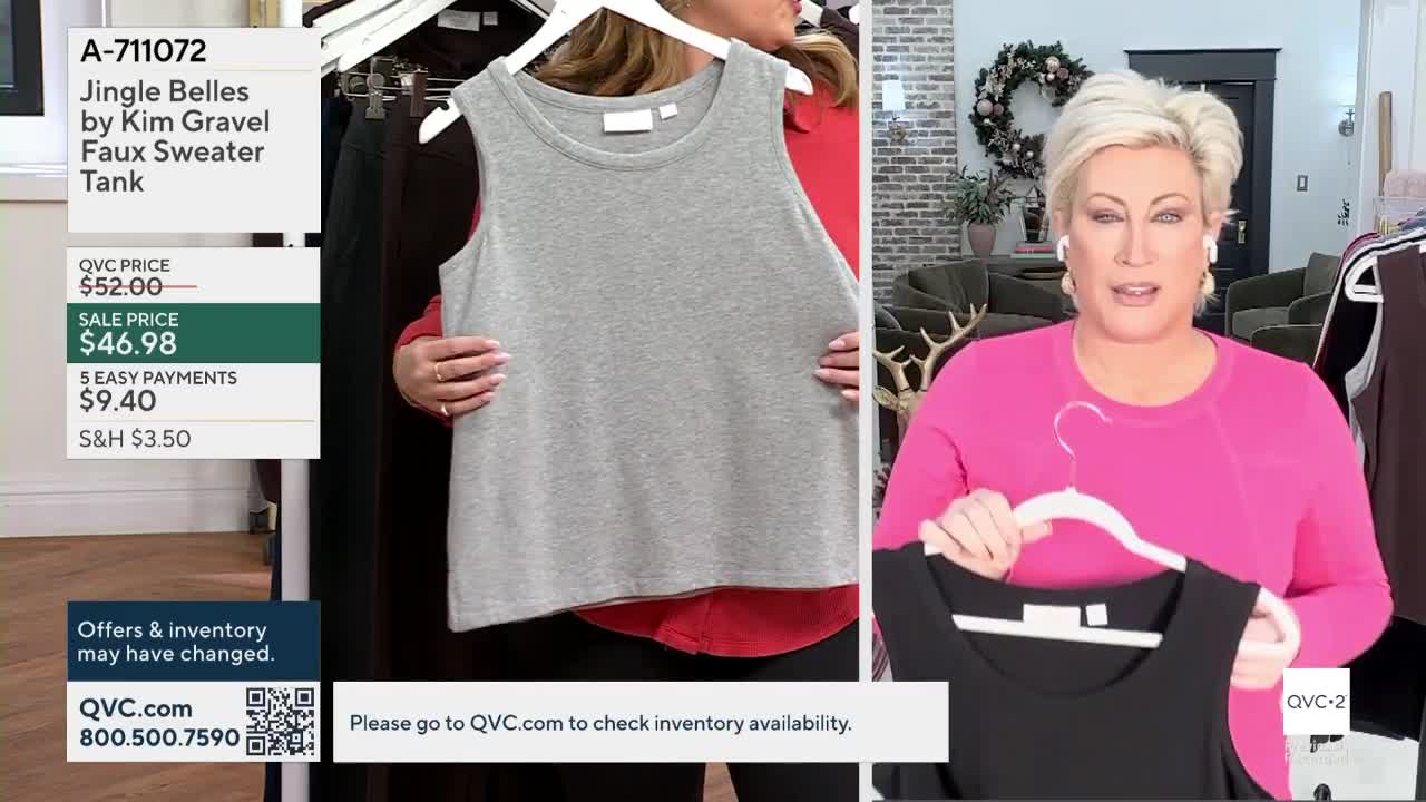 A woman in a pink shirt holds up a black tank top, while another person displays a gray one. On the screen, a QVC2 graphic lists the item's price and details.
