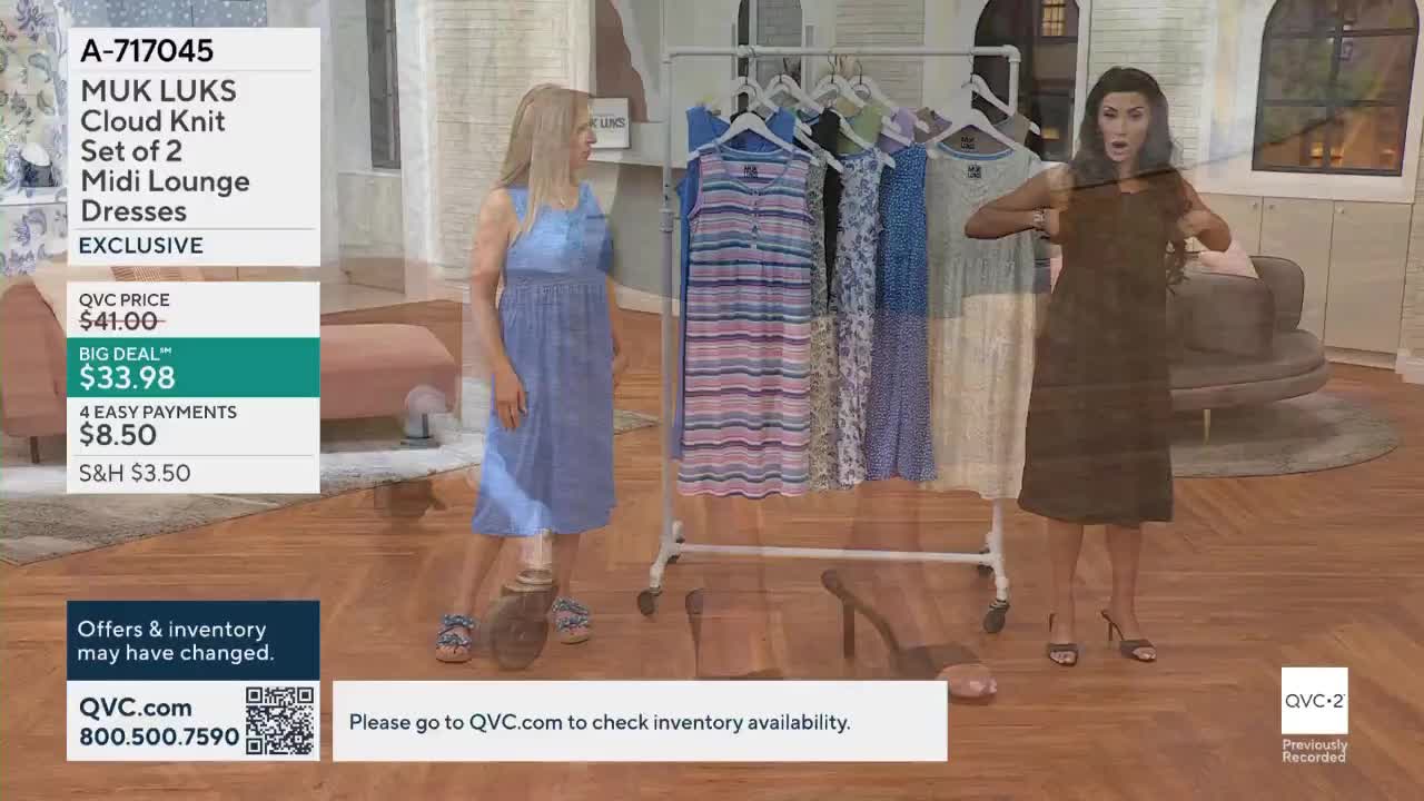 A woman in a blue dress stands beside a rack of colorful dresses. Another woman, wearing a dark dress, adjusts the straps of her garment.