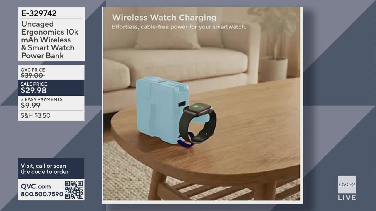 A light blue power bank sits on a wooden table, a smartwatch attached to its side. The watch face glows green, indicating it's charging.