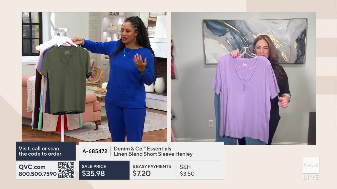 A woman in a royal blue set gestures towards a rack of shirts, one of which is olive green. To her right, another woman holds up a lavender henley shirt.