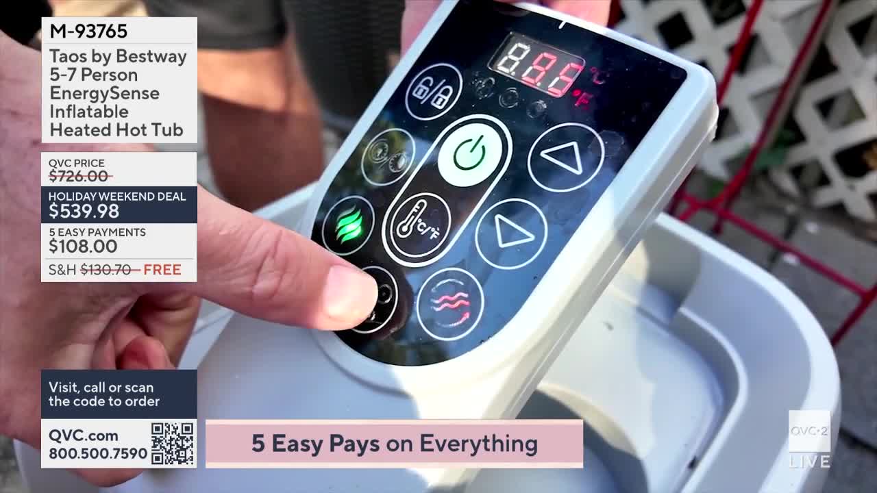 A finger presses a button on the control panel of a hot tub. The screen above displays "8.8.8."