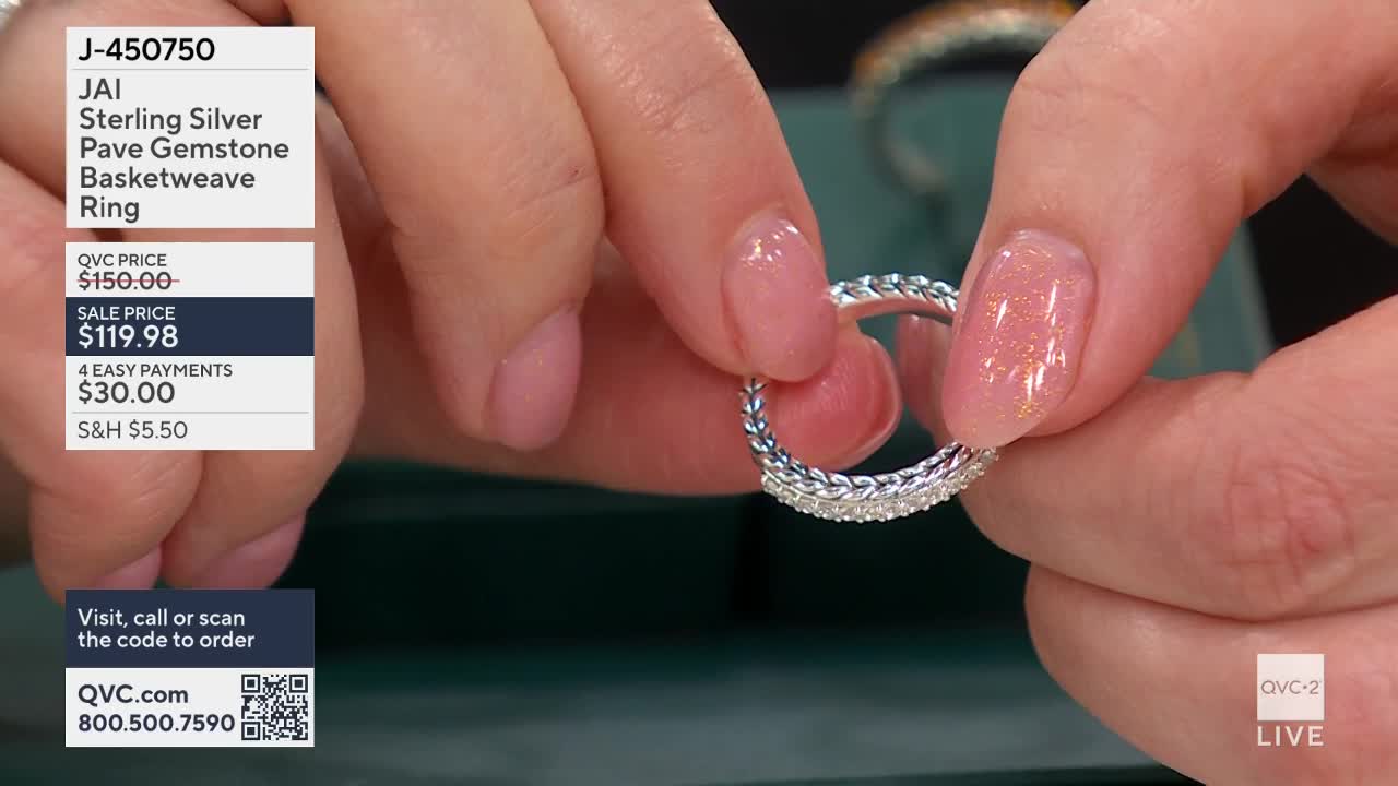 Fingers with sparkly polish turn a sterling silver ring, showing off its braided band and pave-set gemstones. The QVC2 logo appears in the corner, indicating this is a live broadcast from the United States.