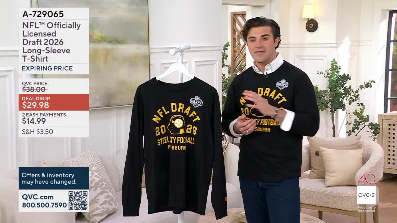 A man in a black long-sleeved shirt gestures animatedly, standing beside a black long-sleeved shirt hanging on a hanger. The shirts both display "NFL DRAFT 2026 STEELTY FOOTBALL PITTSBURGH" in yellow lettering.