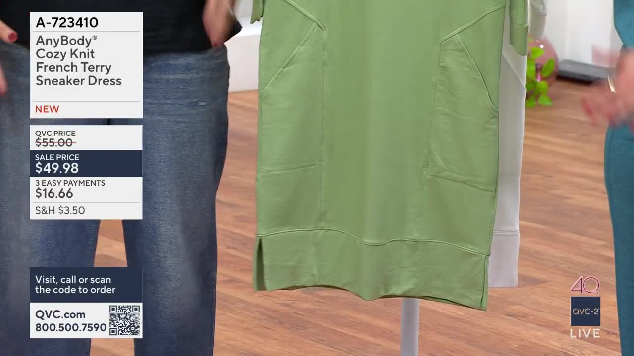 A green dress hangs on a mannequin, its pockets clearly visible. A woman in blue jeans stands to the left, and another in teal is on the right, her hands gesturing.