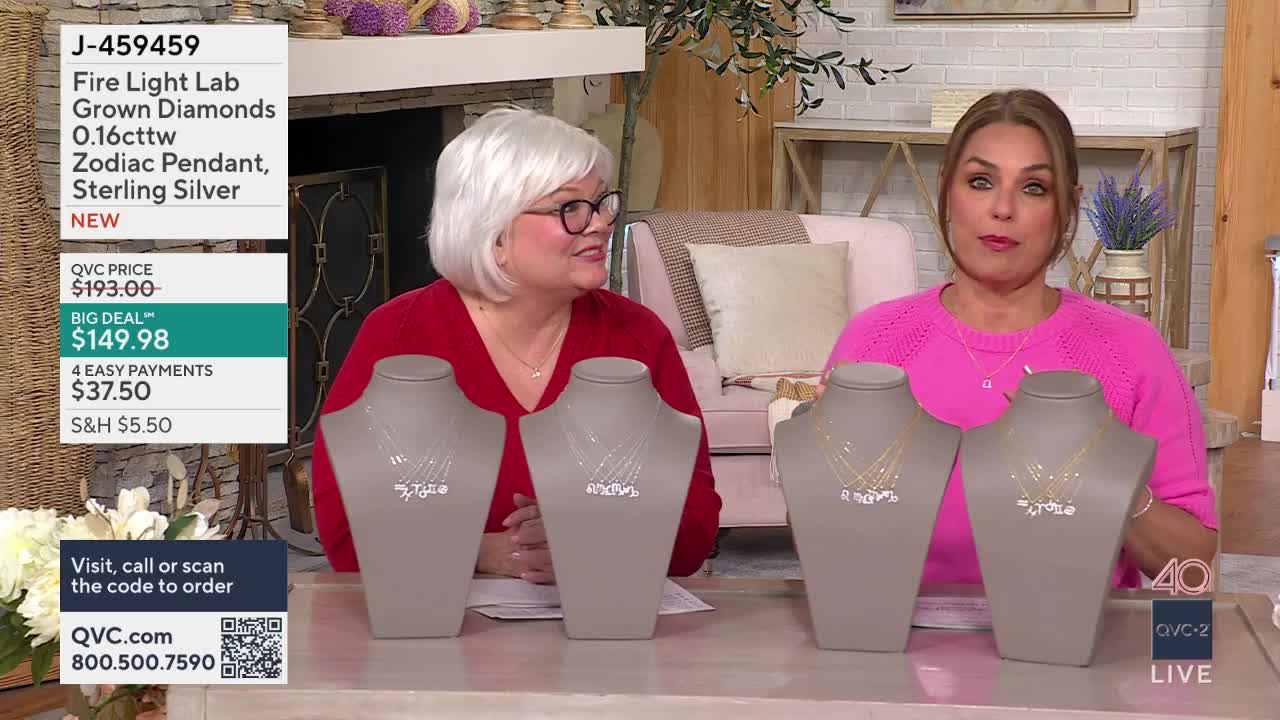 Two women are presenting necklaces on QVC2. The necklaces feature delicate chains with small diamond pendants.