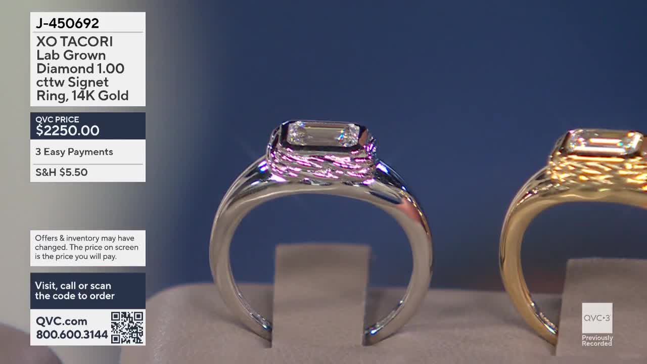 A silver ring with a large, rectangular diamond sits front and center, catching the light. To the right, a gold ring is also on display, both presented on QVC3.
