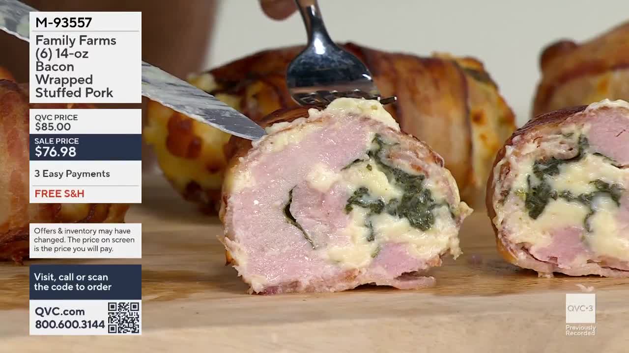 A knife and fork are being used to cut into a bacon-wrapped pork roll, revealing a filling of white cheese and green spinach. The scene is from a previously recorded segment on QVC3, the United States shopping channel.
