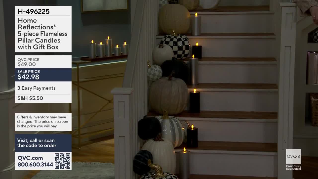 A staircase is decorated with pumpkins and flickering flameless candles, staged for a QVC3 presentation. The product details, including the price and item number, are displayed on the left.

