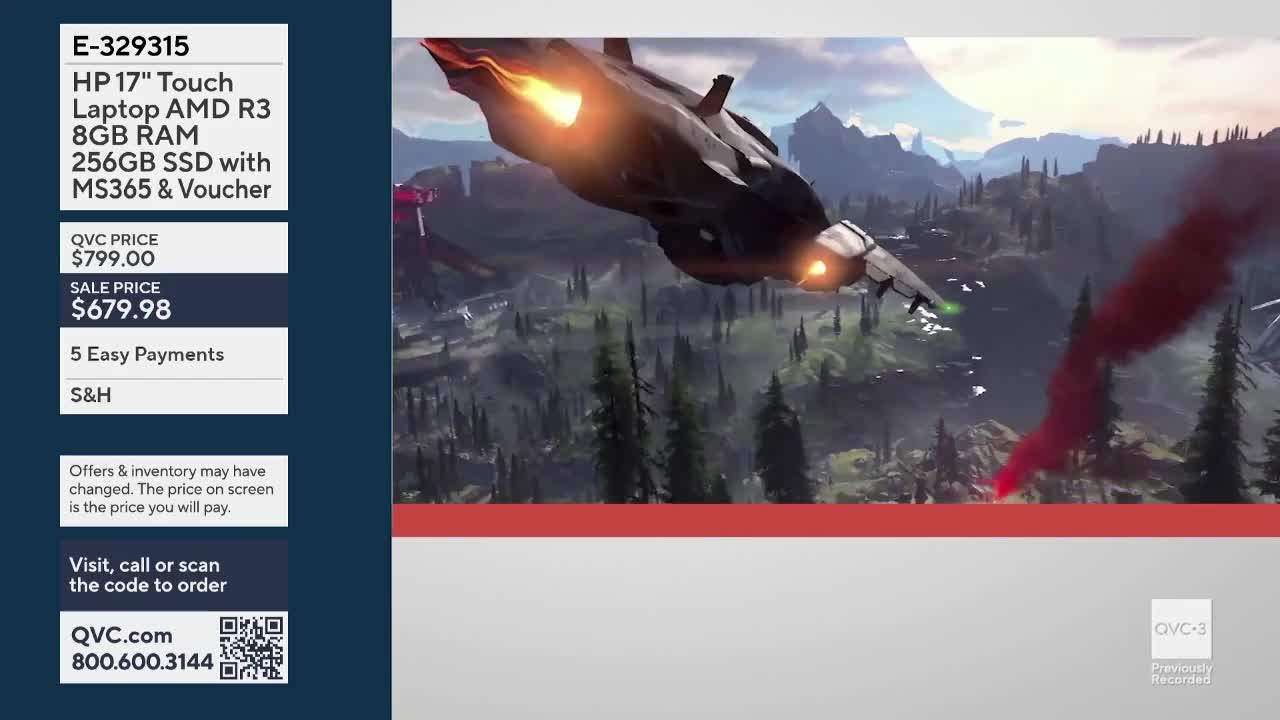 A sleek aircraft, trailing fire, swoops across a mountainous landscape. The QVC3 logo is in the corner, and the screen is selling a laptop.
