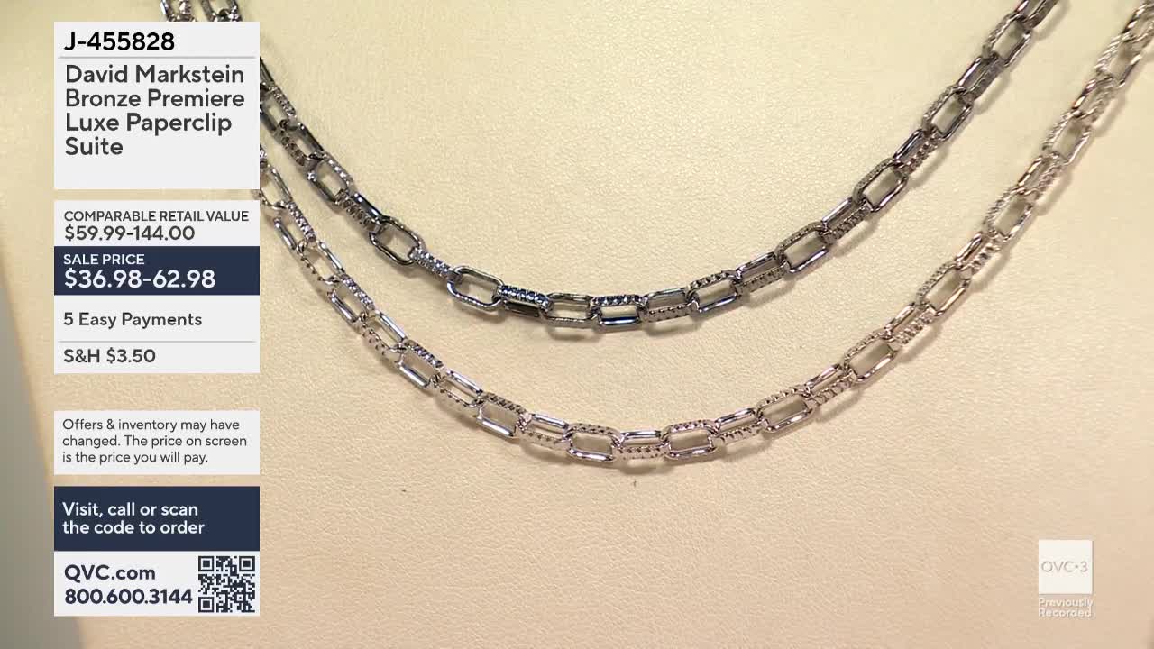 Two silver paperclip chain necklaces are displayed side by side against a neutral background. The QVC3 logo is visible in the corner, and the details of the "David Markstein Bronze Premiere Luxe Paperclip Suite" are shown on the left.
