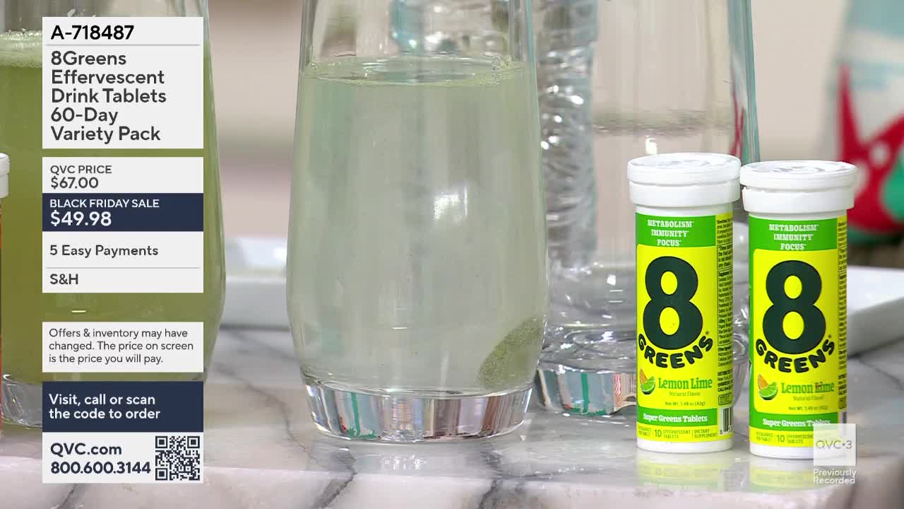A tablet is dissolving in a clear glass, creating a slightly green, fizzy drink. Two tubes of 8Greens tablets sit nearby, advertised on QVC3.
