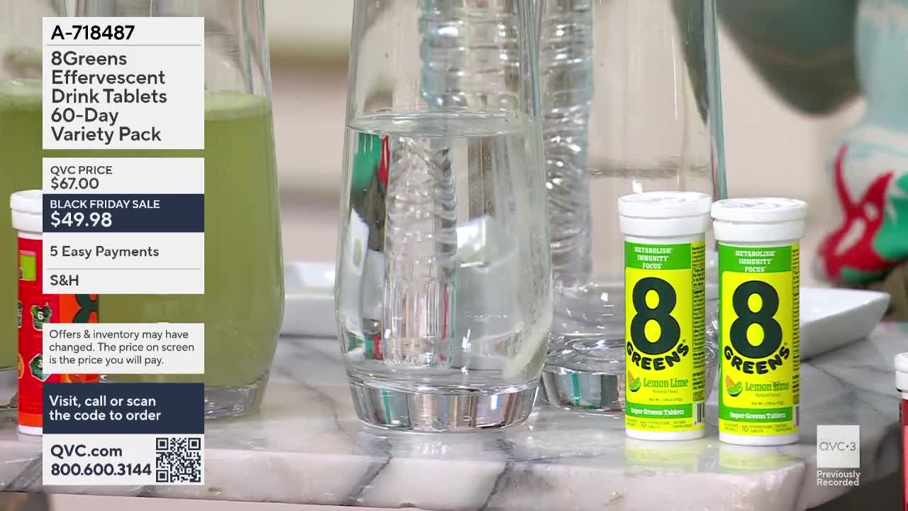 On a marble countertop, two tubes of "8Greens" effervescent tablets sit next to tall glasses of water and a pitcher of green liquid, all under the QVC3 logo. The screen displays a Black Friday sale price for the drink tablets.
