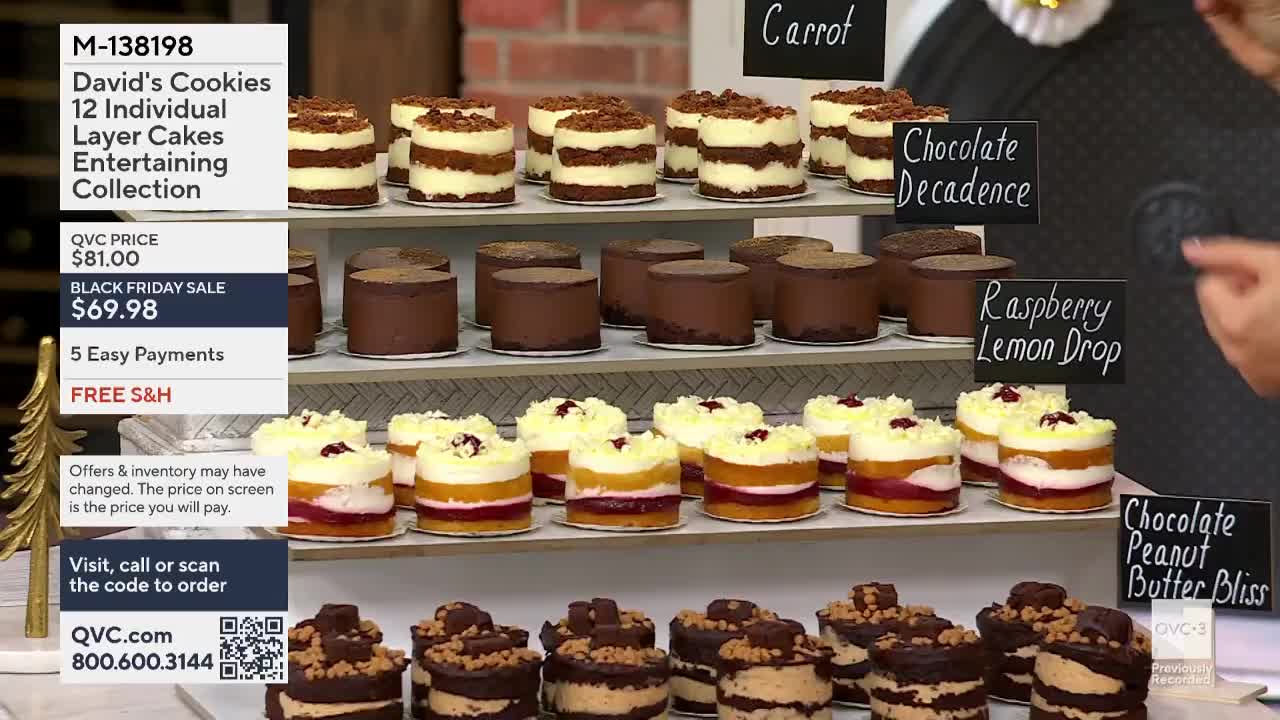A tiered display showcases individual layer cakes, each with a different topping, from the United States-based QVC3. The "Black Friday Sale" price is prominently displayed alongside the "David's Cookies" collection.
