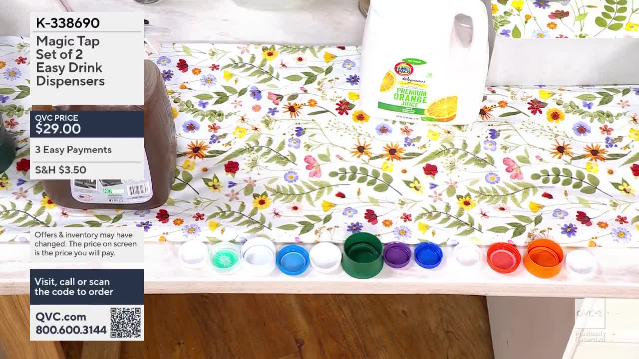 A large jug of orange juice sits next to a dispenser filled with a dark liquid. A row of colorful bottle caps lines the surface in front of them.