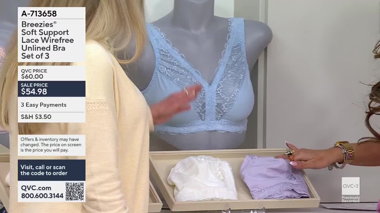 A woman's hand, adorned with rings, reaches for a folded lavender bra. On a mannequin behind her, a light blue bra with lace trim is displayed.