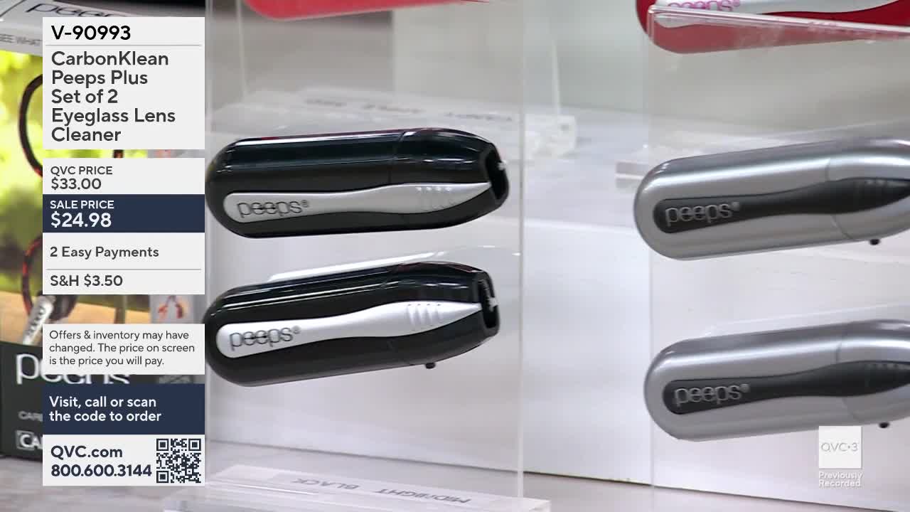 Two black eyeglass lens cleaners sit stacked on a clear display. To their right, two silver versions of the same cleaner are also stacked.