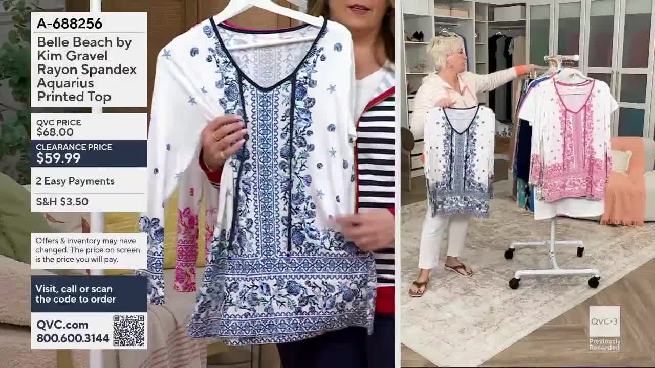 A woman on QVC3 holds up a white top with a blue floral print. Another woman stands nearby, showing a pink version of the same top. A woman on QVC3 holds up a white top with a blue floral print. Another woman stands nearby, showing a pink version of the same top.