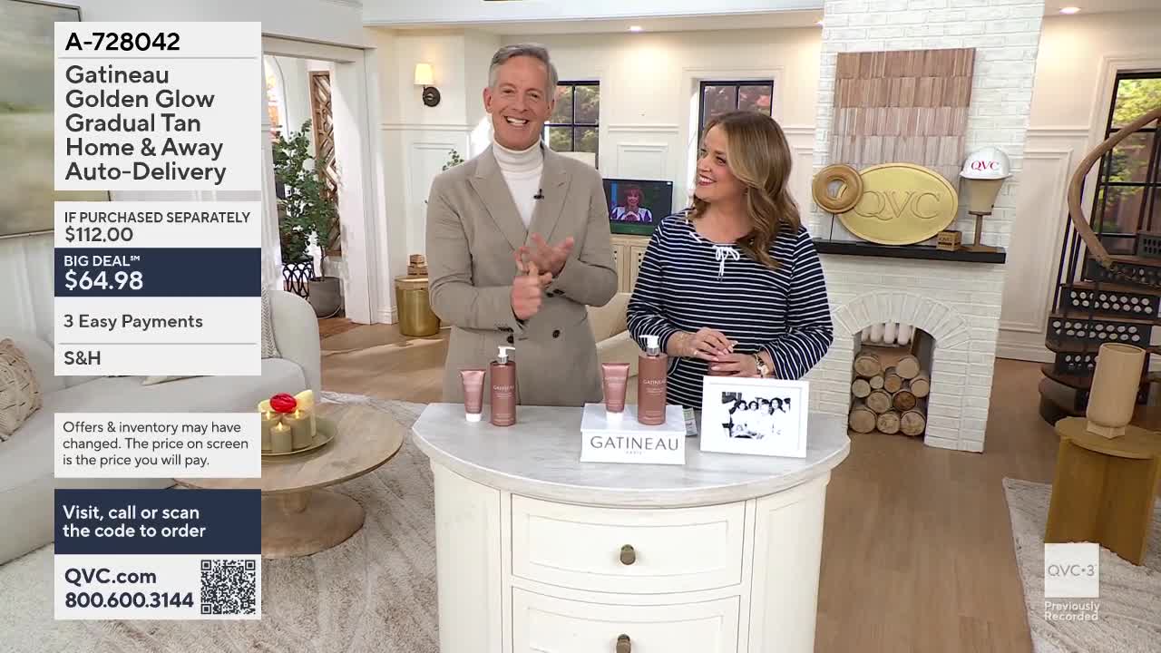 A man in a tan jacket claps his hands, smiling at a woman in a striped shirt. Three bottles of Gatineau Golden Glow sit on a display table between them.