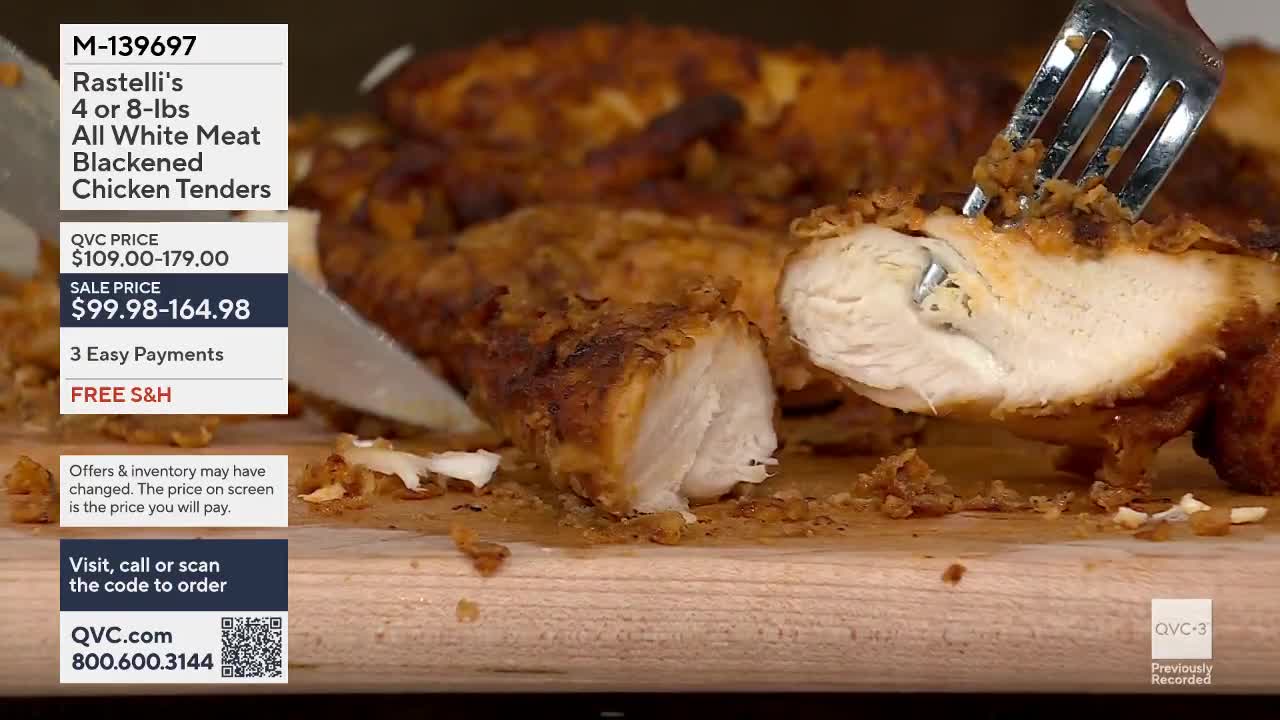 A fork is piercing a breaded chicken tender, revealing its white, juicy interior. Crumbs from the coating scatter across the wooden surface.