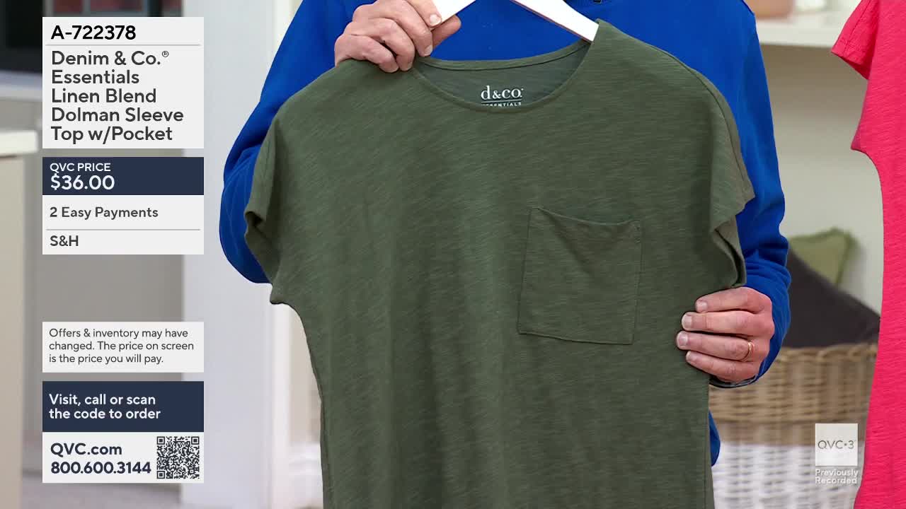 A presenter holds up a green, linen-blend t-shirt with a pocket. Another t-shirt, this one bright pink, hangs to the right.