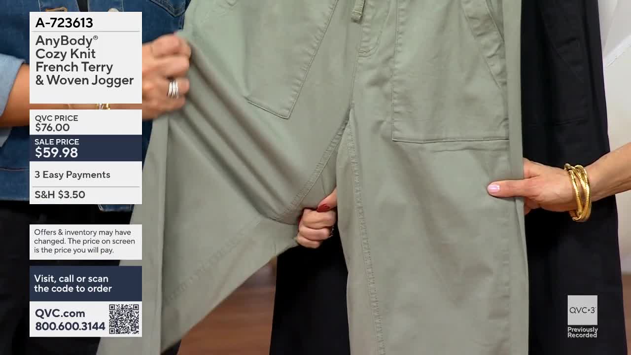 Hands stretch the fabric of a pair of light green joggers. A QVC overlay details the item's price and ordering information.