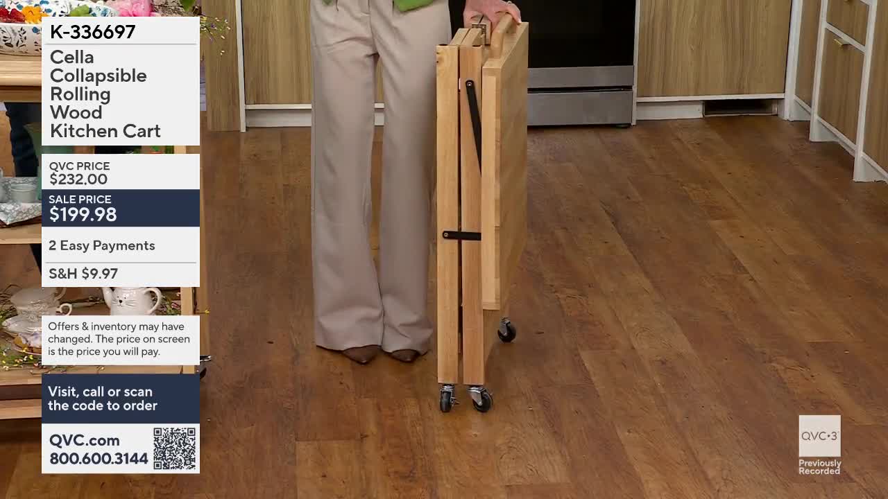 A person is demonstrating a wooden kitchen cart, folded and on wheels. The cart is being moved across a wooden floor.