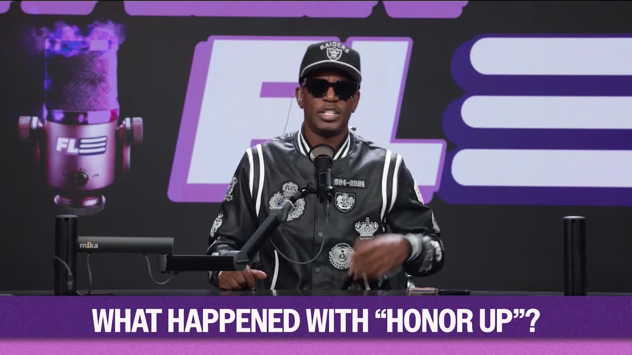A man in a Raiders cap and jacket gestures with his hands, talking into a microphone. The words "WHAT HAPPENED WITH 'HONOR UP'?" are displayed in a purple banner below.
