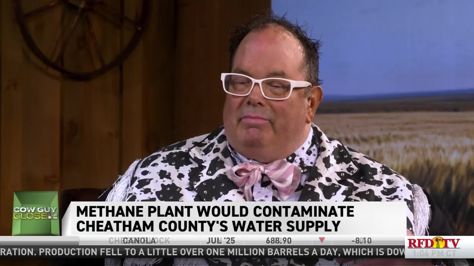 A man in a cow-print jacket is seated, looking slightly down. The RFD-TV chyron states the topic is a methane plant and water contamination.
