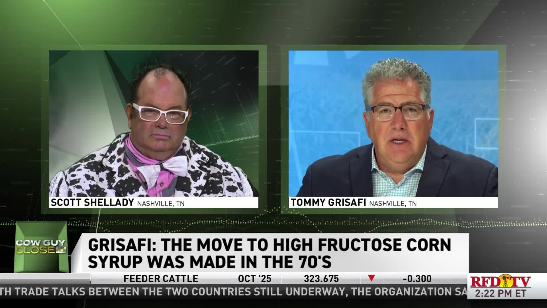 Two men are on screen, each in a separate box, discussing high fructose corn syrup on RFD-TV. One man wears a cow-print jacket and a pink bow tie, while the other, Tommy Grisafi, is in a blue blazer.
