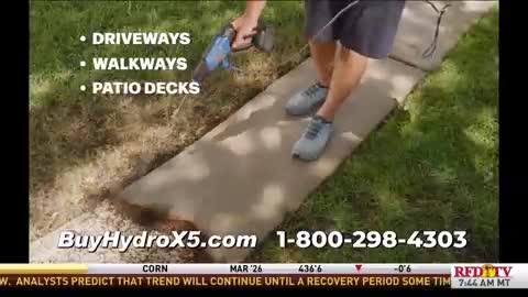 A man in shorts and sneakers is standing on a tan mat, holding a blue power tool. The RFD-TV logo is visible in the corner, along with a phone number for the product being demonstrated.
