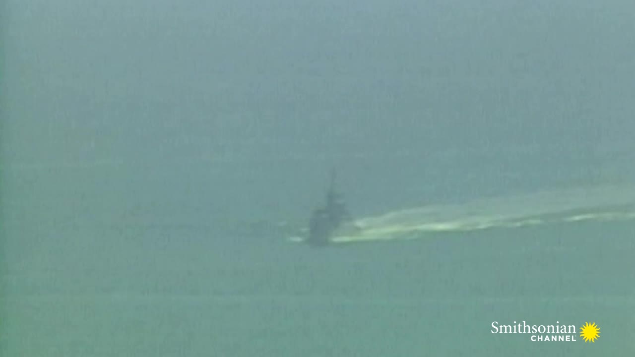 A dark ship is moving across the water, leaving a bright wake behind it. The Smithsonian Channel logo is in the bottom right corner.
